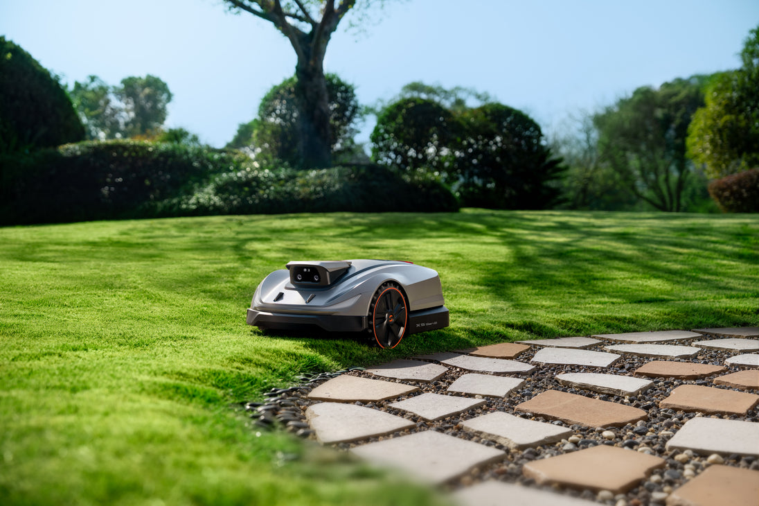 Sunseeker X5 Gen2 mowing a landscaped backyard