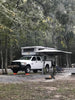 BunduAwn L-Shaped 270 awning installed on truck camper — rear and side coverage