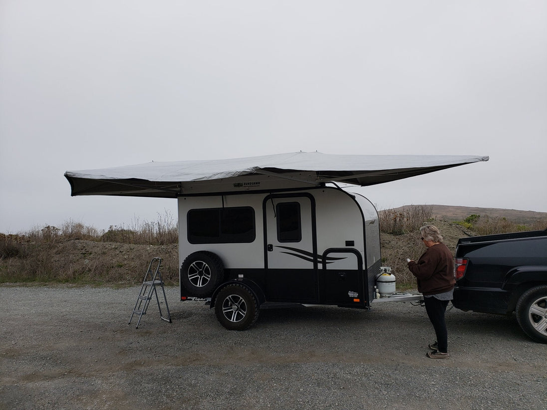 BunduAwn Standard 360 awning fully deployed on a NOBO trailer — three-sided wrap-around coverage