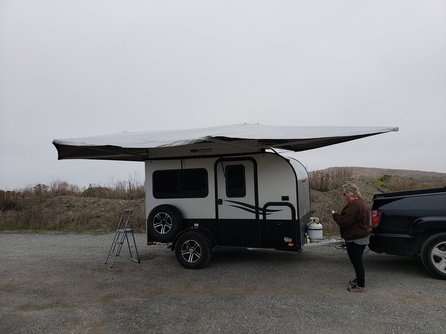 BunduAwn Standard 360 awning fully deployed on a NOBO trailer — three-sided wrap-around coverage
