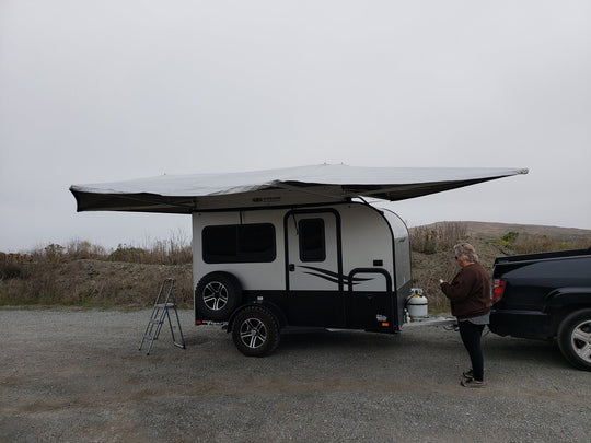 BunduAwn Standard 360 awning fully deployed on a NOBO trailer — three-sided wrap-around coverage