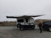 BunduAwn Standard 360 awning fully deployed on a NOBO trailer — three-sided wrap-around coverage