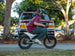 Child riding a Himiway C1 kids e-bike in a driveway