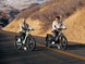 Two riders on Himiway D5 e-bikes on a canyon road