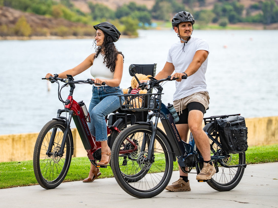 Riders on Himiway A7 e-bikes by a lake