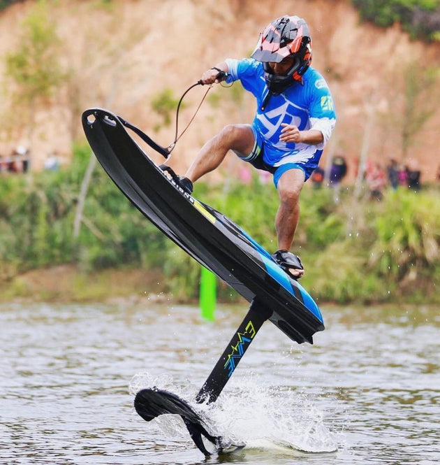 Rider on an EWAVE board with the hydrofoil attachment, foiling above the water