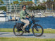 Rider commuting on a Himiway A7 e-bike by a marina