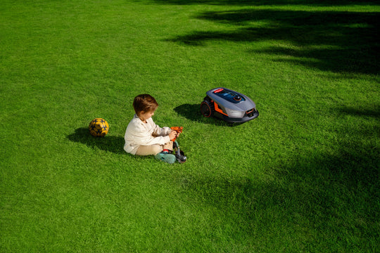 Sunseeker X4 avoiding a child's toys on the lawn