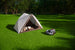 Sunseeker X7 Gen2 mowing beside a family tent in the backyard