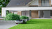Sunseeker X7 Gen2 following the lawn edge beside a modern house