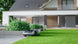 Sunseeker X7 Gen2 following the lawn edge beside a modern house