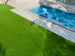 Sunseeker X7+ Gen2 mowing a backyard beside a pool