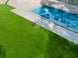 Sunseeker X7+ Gen2 mowing a backyard beside a pool